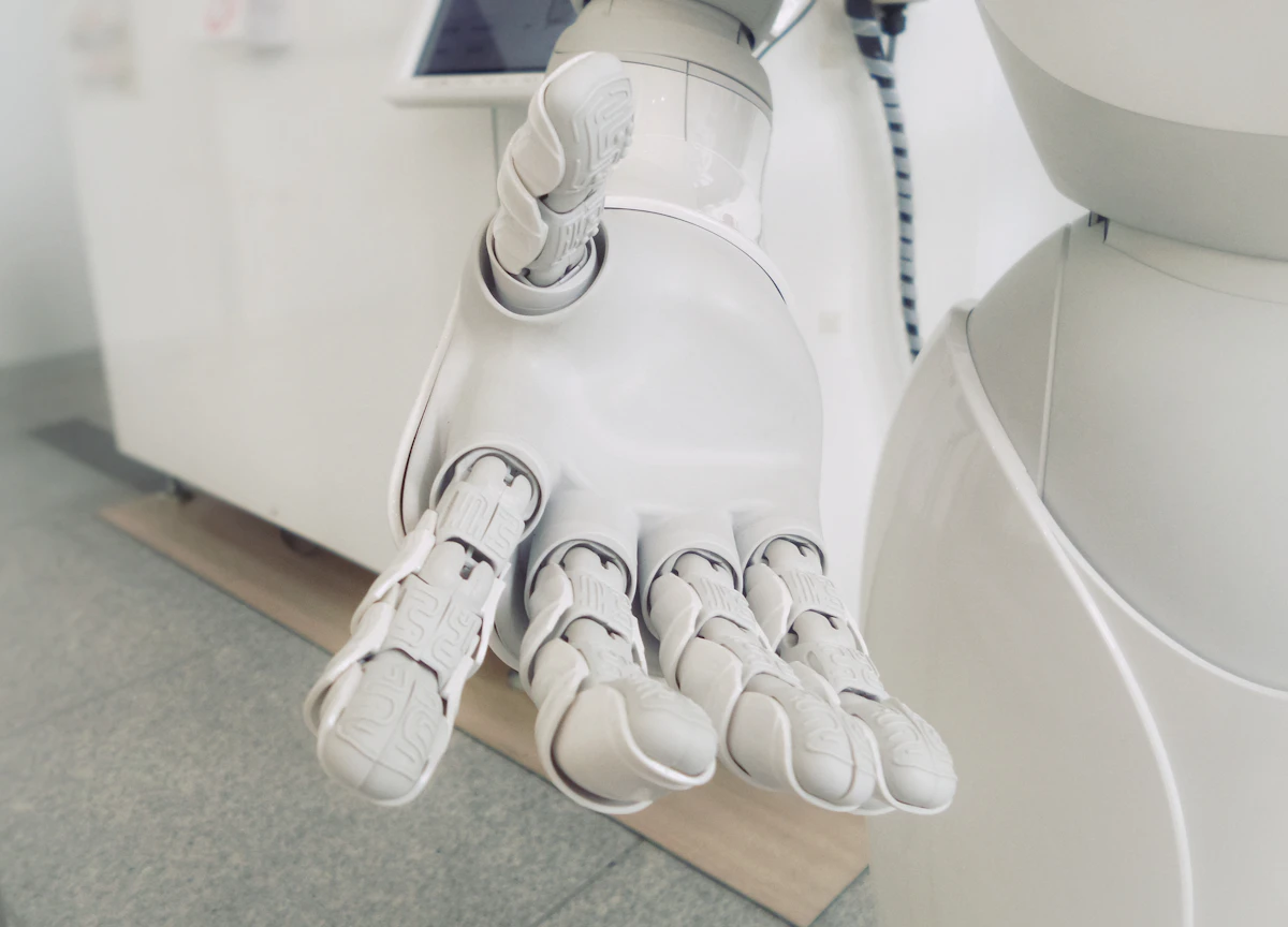 White humanoid robot hand held out, palm up